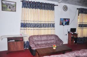 a living room with a couch and a table at Impress Holiday Home in Anuradhapura