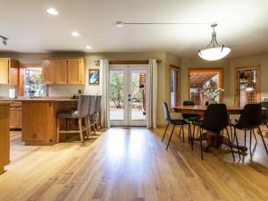 a kitchen and dining room with a table and chairs at Naturbyn Cabin in Glacier