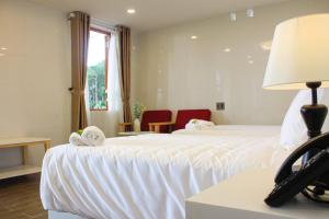 Postel nebo postele na pokoji v ubytování Omirita Resort Dalat