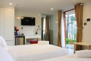 Postel nebo postele na pokoji v ubytování Omirita Resort Dalat