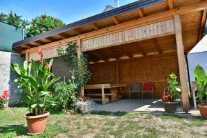 a wooden pavilion with a table and chairs in a yard at Apartments and rooms with parking space Rakovica, Plitvice - 20647 in Rakovica