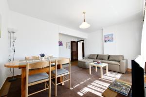 a living room with a table and a couch at Apartments and rooms with parking space Rakovica, Plitvice - 20647 in Rakovica