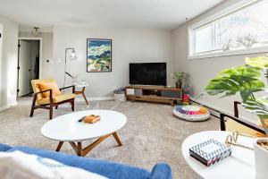 a living room with a couch and a tv at THE SHORELINE- Beach Access, Ocean Views, Private in Kodiak