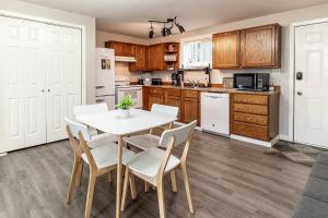 a kitchen with a table and chairs in a room at THE SHORELINE- Beach Access, Ocean Views, Private in Kodiak