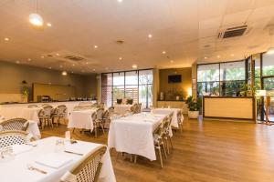 a dining room with white tables and chairs at Contour Hotel Katherine in Katherine