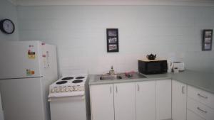 a kitchen with a white refrigerator and a sink at Unit 3 Beachcomber, Arcadia in Arcadia