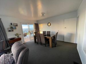 a living room with a dining room table and chairs at Home with a view in Otorohanga