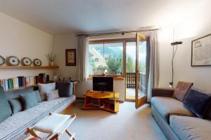 a living room with two couches and a tv at Apartment Pradè in Samedan
