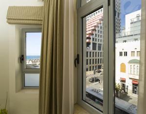 Cette chambre dispose d'une fenêtre offrant une vue sur l'océan. dans l'établissement Bell Boutique and Spa Hotel, à Tel Aviv