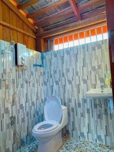 a bathroom with a toilet and a sink at Quiet Garden View Lodge&Trekking in Banlung