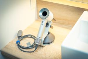 a security camera sitting on the floor with a hose at BEB5 Okinawa Seragaki by Hoshino Resorts in Onna