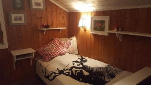 Chalet Chic mit Hot Pot في ويلدهاوس: غرفة نوم بسرير وصورة بقرة