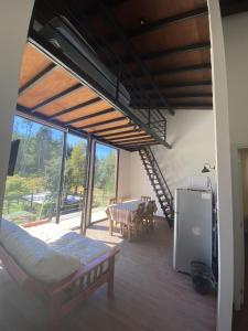 a room with a bed and a dining room with a table at Patagonialiv in San Carlos de Bariloche