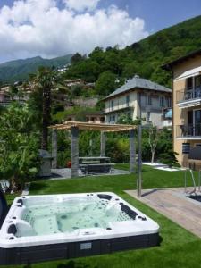 einen Whirlpool im Hof eines Hauses in der Unterkunft Casa Ghiggi - Zweizimmerwohnung "Ticino" in Brissago