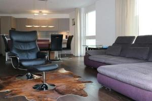 a living room with a couch and a chair at Chavallera Casa Torri in St. Moritz