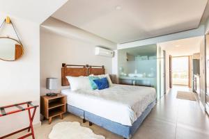 a bedroom with a large bed and a bathroom at Beachfront & free daily breakfast & 600MB 7010 Wifi by Moikkarentals in Puerto Vallarta +67 photos