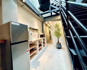 a kitchen with a refrigerator and a counter in a room at Armenian Guest House by LOLZ for 22pax in George Town