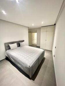 a bedroom with a large bed and white walls at Brand-new apartments in the heart of Brussels in Brussels