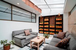 a living room with two couches and a table at 100 Wonderful House in Bogotá