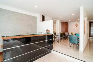 a dining room and kitchen with a table and chairs at 100 Wonderful House in Bogotá