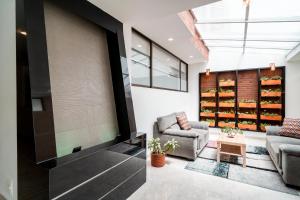 a living room with two chairs and a table at 100 Wonderful House in Bogotá