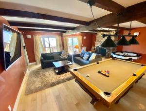 a living room with a pool table in it at Modern 6 bedroom retreat, stunning lake views, close to village! in Lake Arrowhead