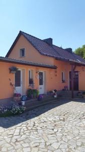 a house with a stone driveway in front of it at Appartement in Buchenhain mit Großem Garten in Buchenhain