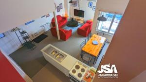 an overhead view of a living room with red furniture at Razorback 2 in Jindabyne