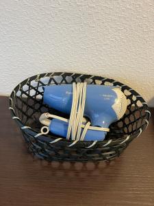 a basket with utensils and pasta in it at BiBi Hotel 泊ポート in Naha