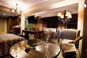 a living room with a couch and a glass table at Danai Hotel & Spa in Olympic Beach