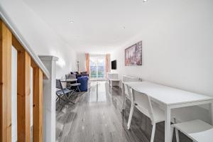 a white dining room with a white table and chairs at Entire House - Three Bed House in Peckham in London