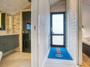 a bathroom with a blue mat on the floor at 6 person holiday home in Løkken-By Traum in Løkken
