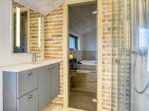 a bathroom with a shower and a sink and a toilet at 6 person holiday home in Løkken-By Traum in Løkken +17 photos