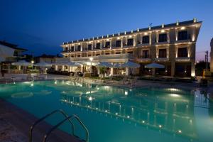 a swimming pool in front of a hotel at night at Danai Hotel & Spa in Olympic Beach