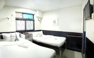 Postelja oz. postelje v sobi nastanitve Apple Hostel 蘋果賓館
