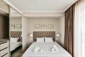 a bedroom with two beds and a mirror at Sea lounge in Varna City