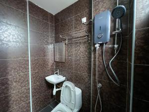 a bathroom with a shower with a toilet and a sink at Ins2 Langkawi Apartment Kuah in Kuah