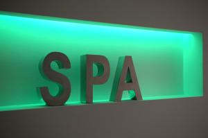 a green sign with the word spa on a wall at Danai Hotel & Spa in Olympic Beach