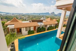 a view from the balcony of a house with a swimming pool at Andakiri Private Pool Villa Sea View in Ao Nang Beach