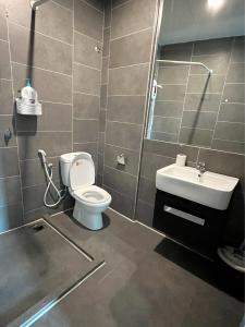 a bathroom with a toilet and a sink at Homey Studio Empire Damansara FreeWiFi Netflix in Petaling Jaya