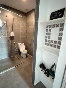 a bathroom with a toilet and a shower at Homey Studio Empire Damansara FreeWiFi Netflix in Petaling Jaya