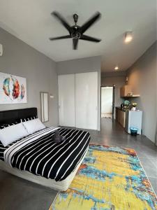 a bedroom with a bed and a ceiling fan at Homey Studio Empire Damansara FreeWiFi Netflix in Petaling Jaya