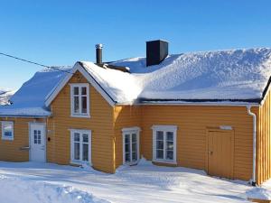 a wooden house with snow on the roof at 5 person holiday home in Skutvik in Skutvika