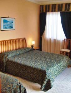 Postel nebo postele na pokoji v ubytování Hotel Miramare