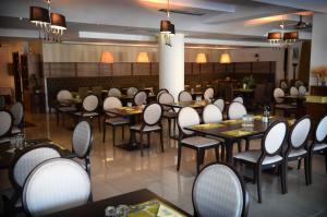 a restaurant with tables and chairs in a room at Danai Hotel & Spa in Olympic Beach