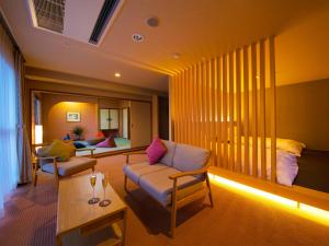 a living room with a couch and a table at Iki Stellacote Taiankaku in Iki