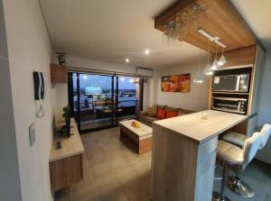 a kitchen and living room with a view of a living room at Acogedor Departamento Vista a Cordillera in Godoy Cruz
