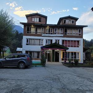a building with a car parked in front of it at New Snow View Resort pahalgam in Pahalgām
