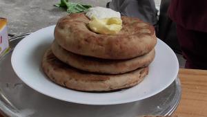 a stack of bagels on a plate on a table at Skayil House in Nubra
