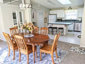 a kitchen and dining room with a wooden table and chairs at Spacious Peaceful Country Home 1 Mile from Town 